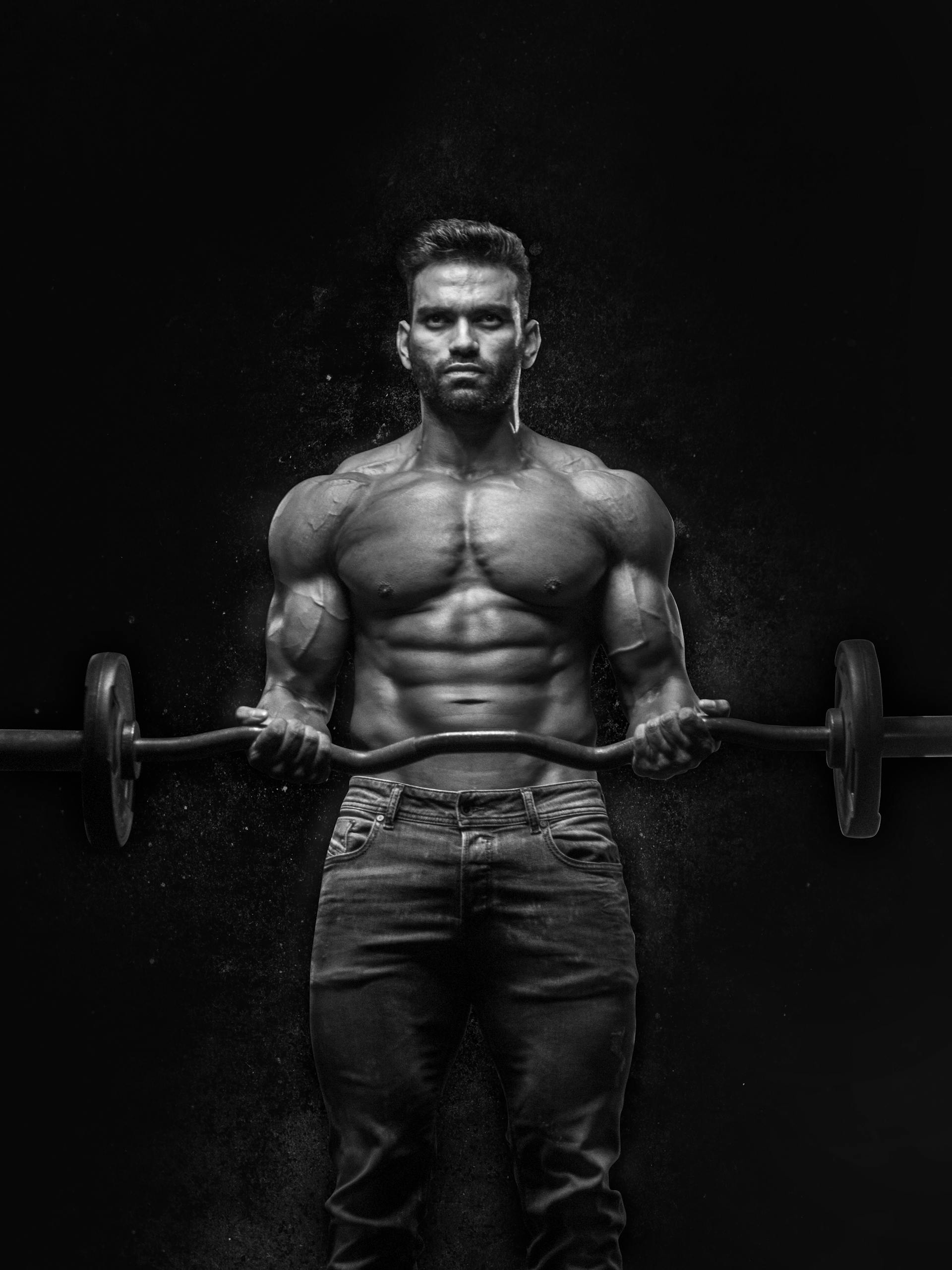 Athlete lifting weights in a dark gym